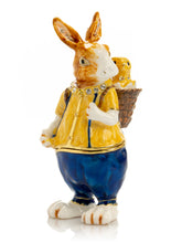 Keren Kopal Easter bunny carrying a baby chick on a basket